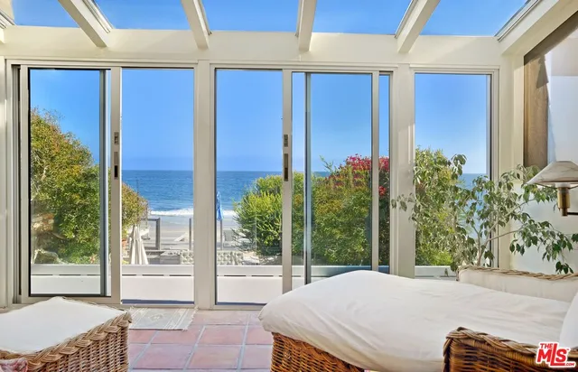 a bedroom with a bed and a potted plant