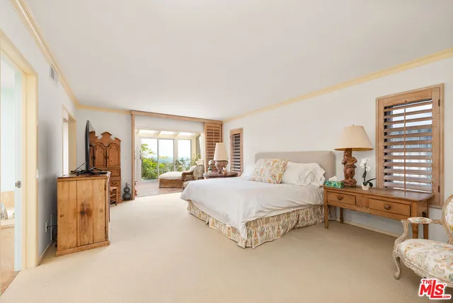 a spacious bedroom with a bed and a couch