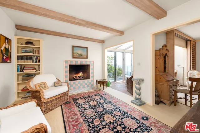 a living room with furniture a rug and a fireplace