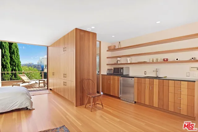 a view of a living room hardwood floor and a large window