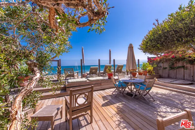 a view of a patio with chairs and a table