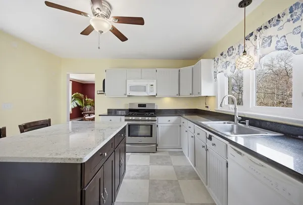 a kitchen with a stove sink and cabinets