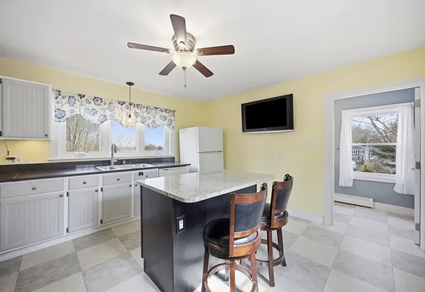a living room with granite countertop furniture and a flat screen tv