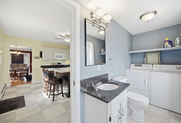 a bathroom with a sink a toilet and a mirror