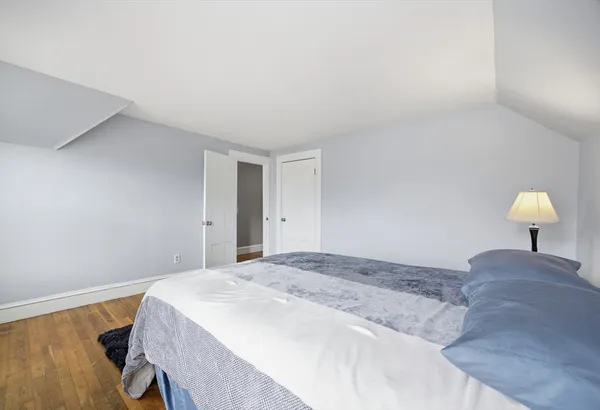 a bedroom with a bed and a lamp on table