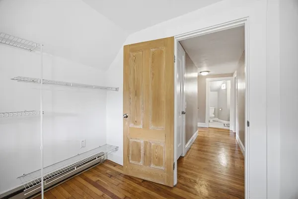 a view of a hallway with wooden floor