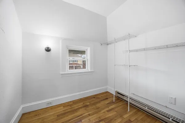 a view of room with window and hardwood floor