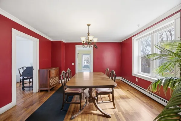 a view of a dining room with furniture and chandelier