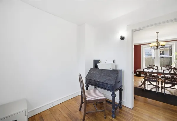 a view of a workspace with furniture and wooden floor