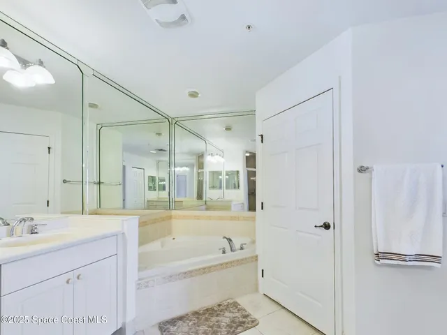 a bathroom with a bathtub shower and a sink