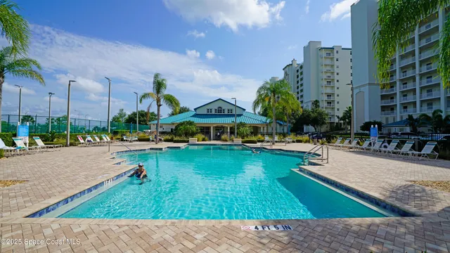 a swimming pool with outdoor seating and yard