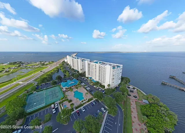 an aerial view of a houses with a yard
