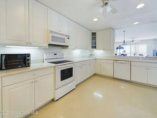a kitchen with white cabinets stainless steel appliances and sink