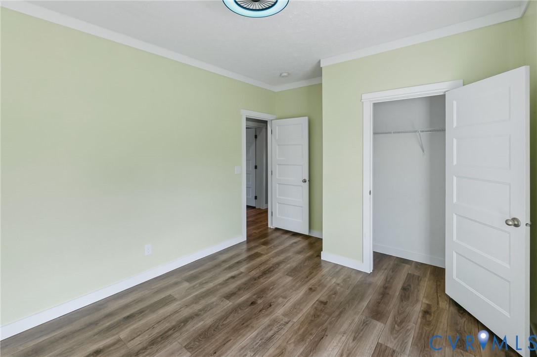 13110 Continental Road Wilsons, VA 23894 - Photo 25 of 35 Wood-finish flooring, light green walls, white tri