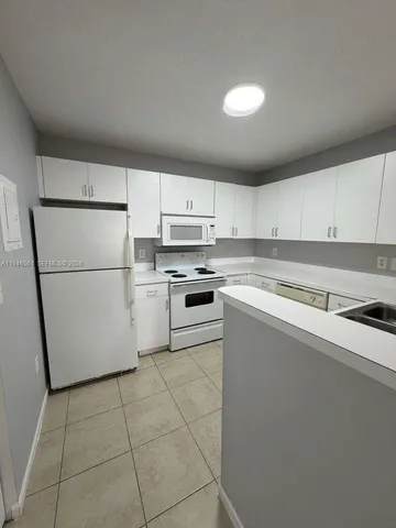 a kitchen with cabinets stainless steel appliances and a sink