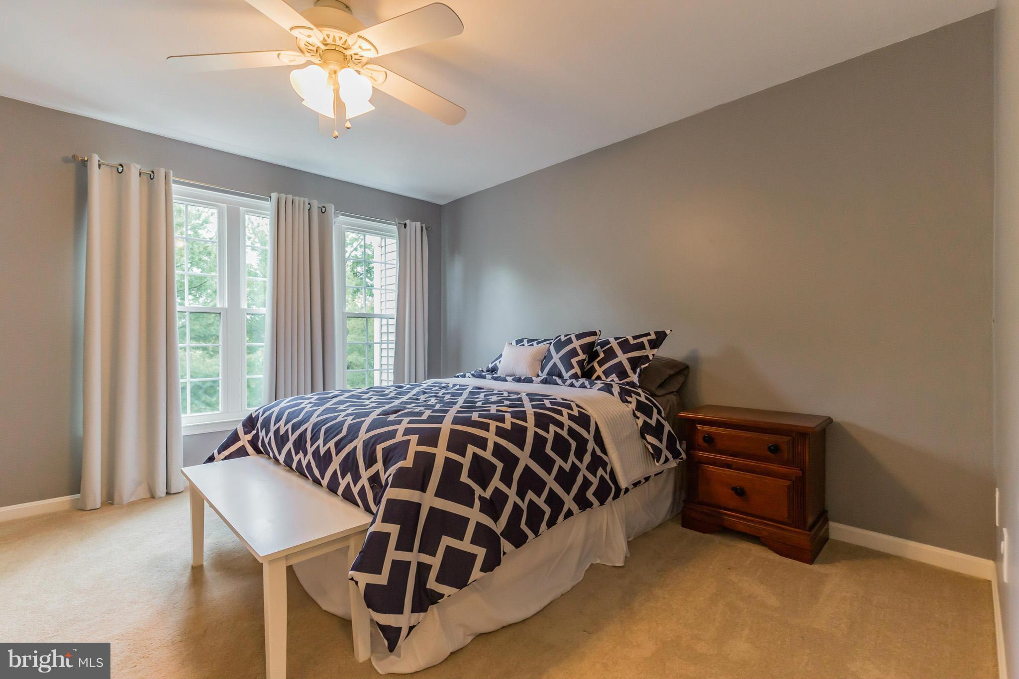 4436 Cole Farm Road Baltimore, MD 21236 - Photo 15 of 30 a bed sitting in a bedroom next to a window