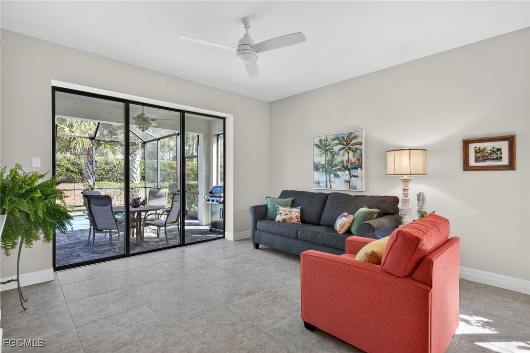 11268 Carlingford Road Fort Myers, FL 33913 - Photo 12 of 48 a living room with furniture and a floor to ceiling window