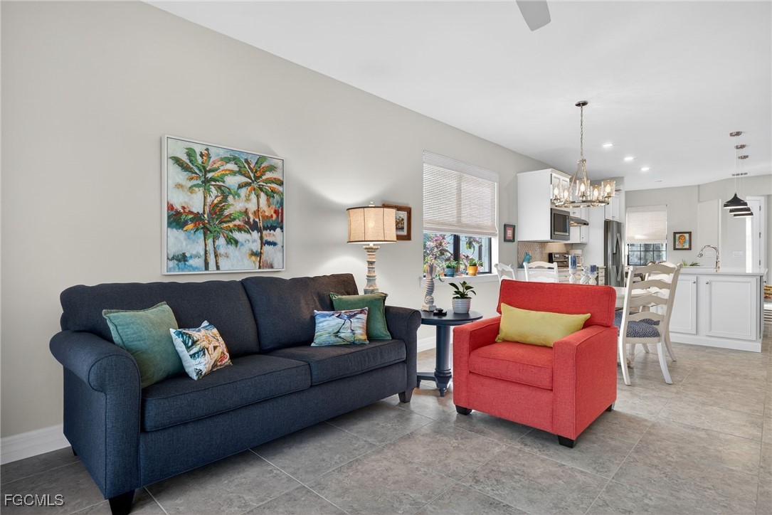 11268 Carlingford Road Fort Myers, FL 33913 - Photo 13 of 48 a living room with furniture kitchen view and a chandelier