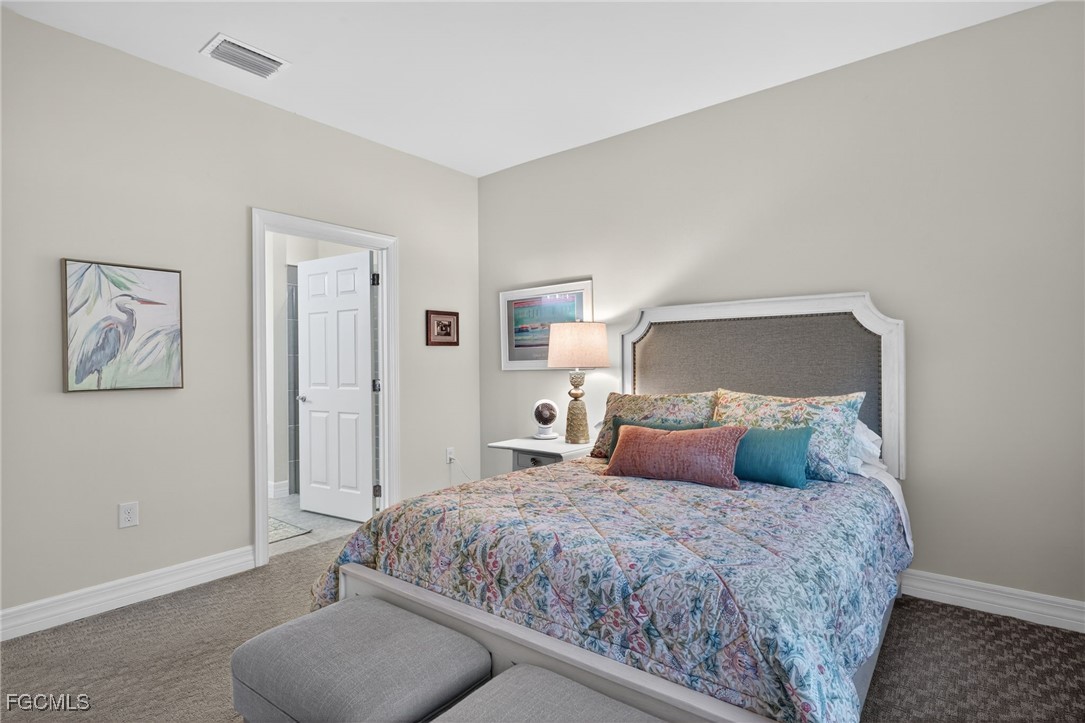 11268 Carlingford Road Fort Myers, FL 33913 - Photo 17 of 48 a bedroom with a large bed and a couch