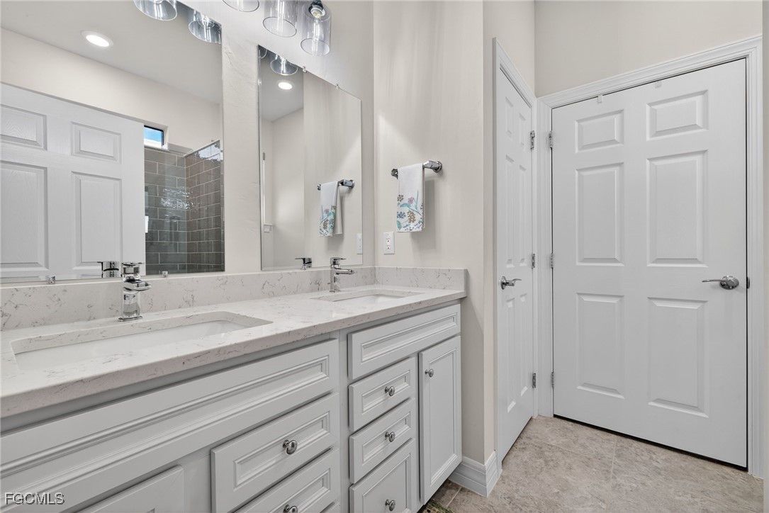 11268 Carlingford Road Fort Myers, FL 33913 - Photo 19 of 48 a bathroom with a double vanity sink and mirror