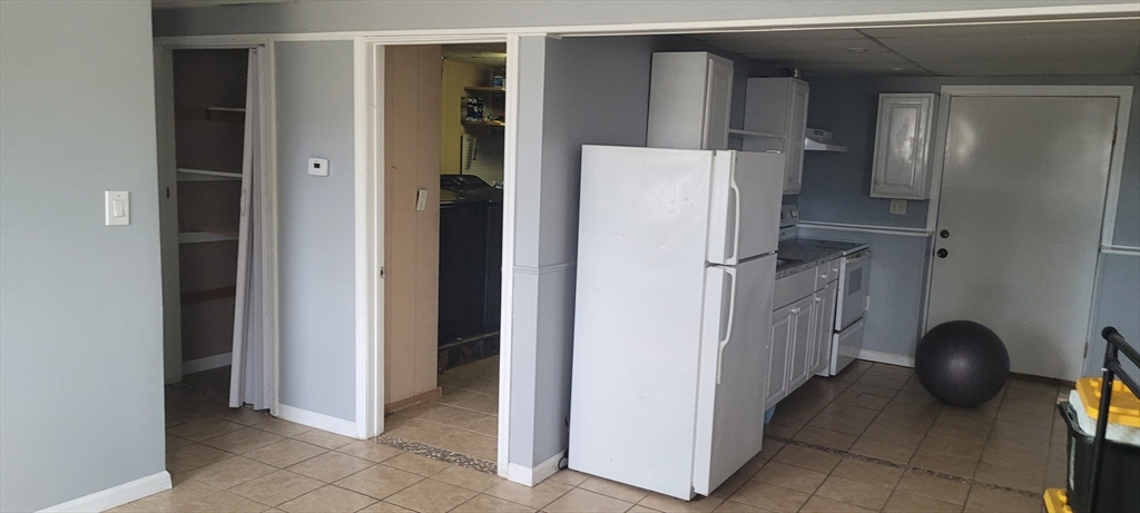 479 SOUTH Taunton Ma, Unit 1 Taunton, MA 02780 - Photo 1 of 5 a view of a kitchen with refrigerator and natural light
