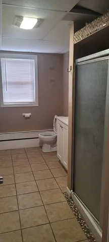 a bathroom with a toilet and a shower
