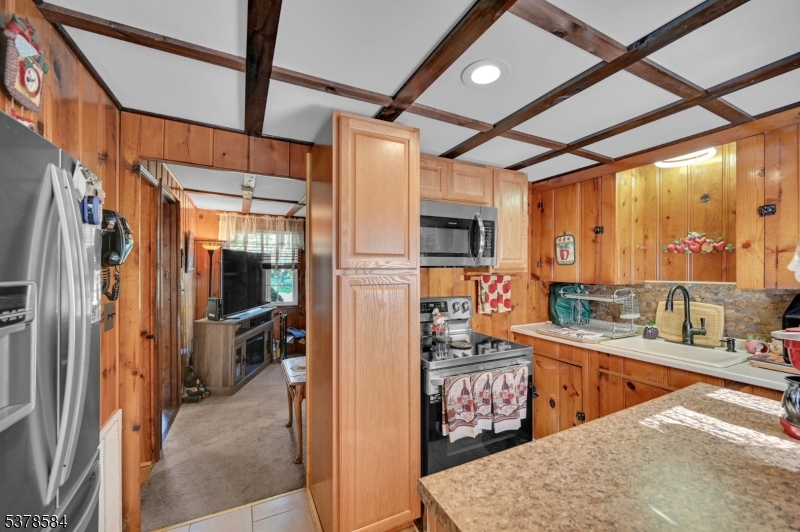 134 Birch Road Vernon, NJ 07422 - Photo 16 of 49 a kitchen with stainless steel appliances kitchen island granite countertop a refrigerator and a sink