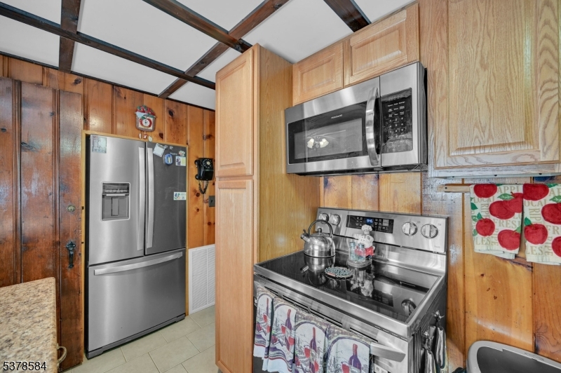 134 Birch Road Vernon, NJ 07422 - Photo 21 of 49 a kitchen with stainless steel appliances granite countertop a stove and a refrigerator