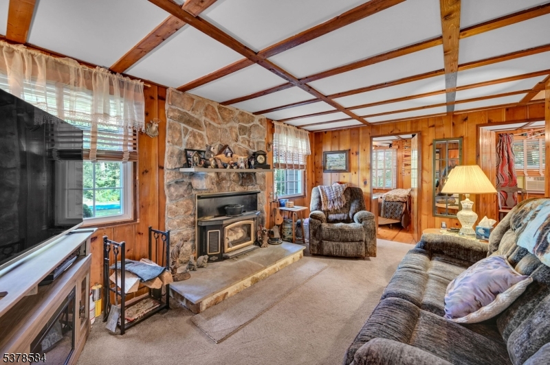 134 Birch Road Vernon, NJ 07422 - Photo 8 of 49 a living room with furniture a flat screen tv and windows