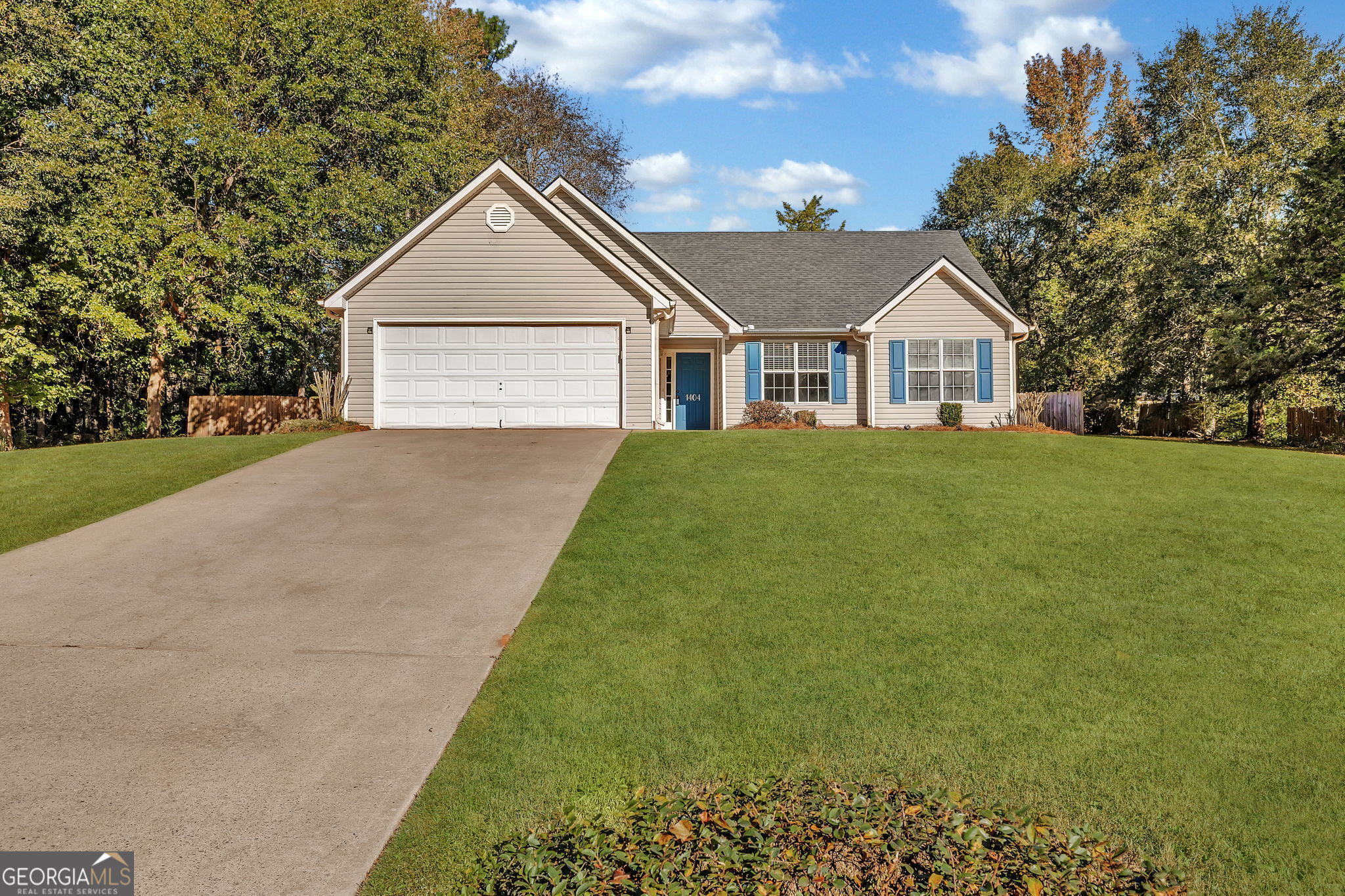 a front view of house with yard and green space