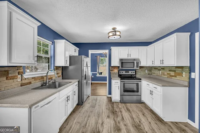a kitchen with refrigerator cabinets and wooden floor