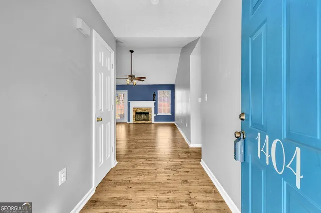 a view of a hallway with wooden floor and staircase