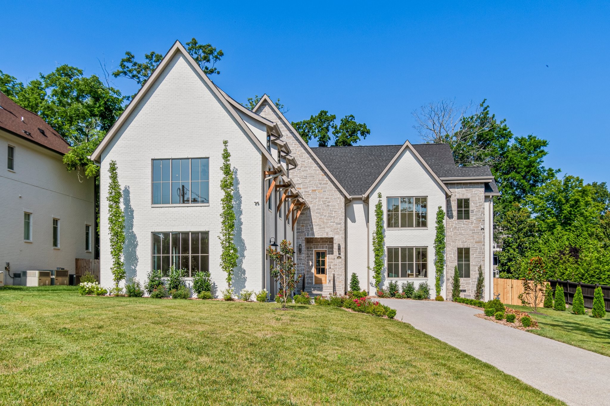 4035 Sneed Road Nashville, TN 37215 - Photo 3 of 64 a view of a big house with a big yard and large trees