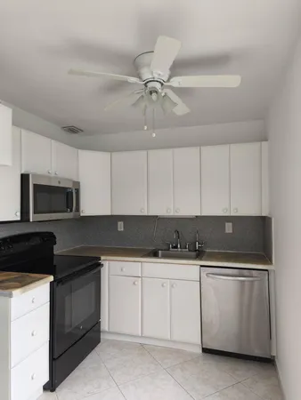 a kitchen with a stove cabinets and a sink