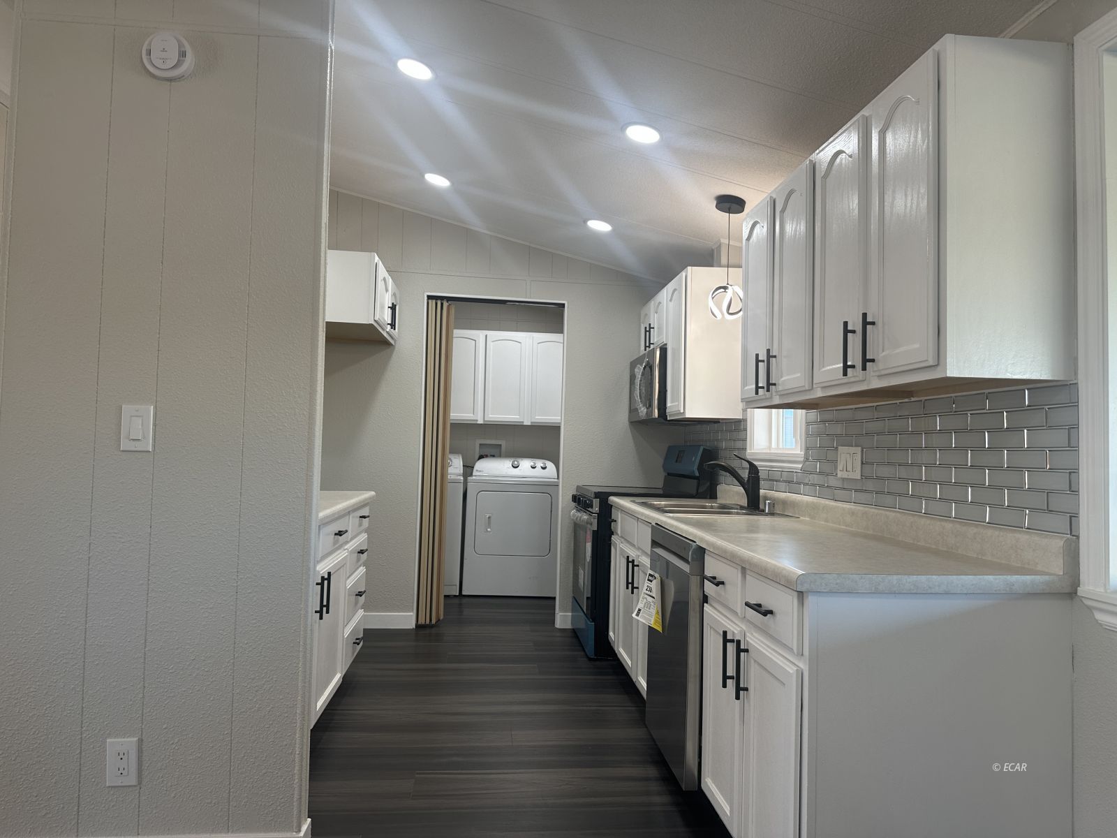 940 Spring Valley Parkway Spring Creek, NV 89815 - Photo 9 of 25 a kitchen with stainless steel appliances granite countertop a sink stove and refrigerator