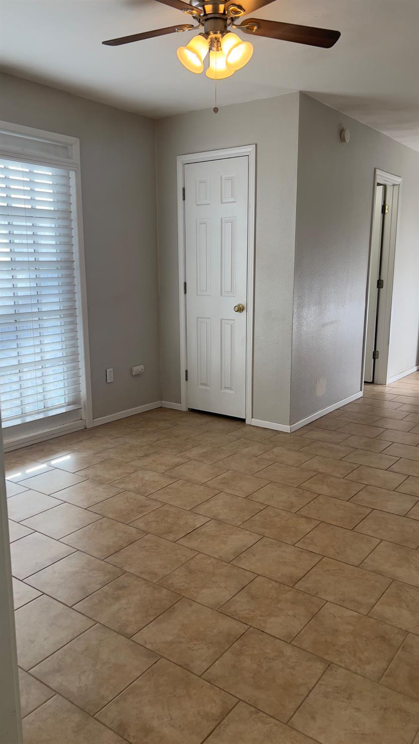 2714 29th Street Lubbock, TX 79410 - Photo 17 of 20 a view of an empty room with window and wooden floor