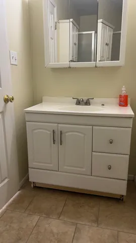 a bathroom with a glass shower door