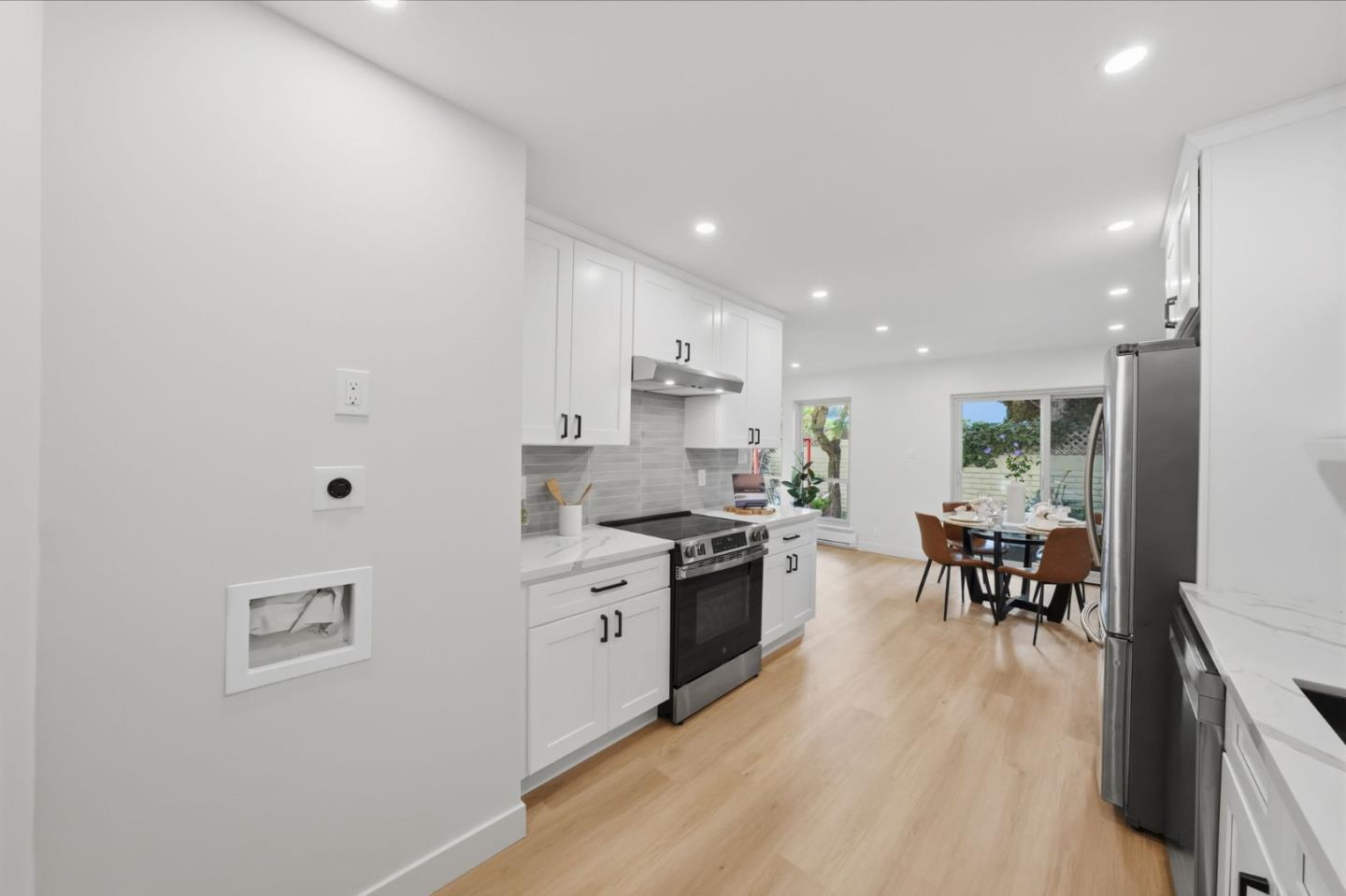 409 Puerto Place Hayward, CA 94541 - Photo 20 of 54 a large kitchen with stainless steel appliances a large counter top a stove a chimney a sink and a refrigerator