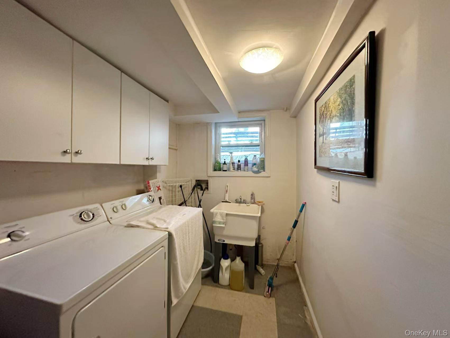 28-07 172nd Street Queens, NY 11358 - Photo 8 of 10 Laundry room with washer and dryer and cabinet space