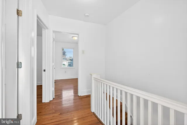 a view of a small space with wooden floor and a window