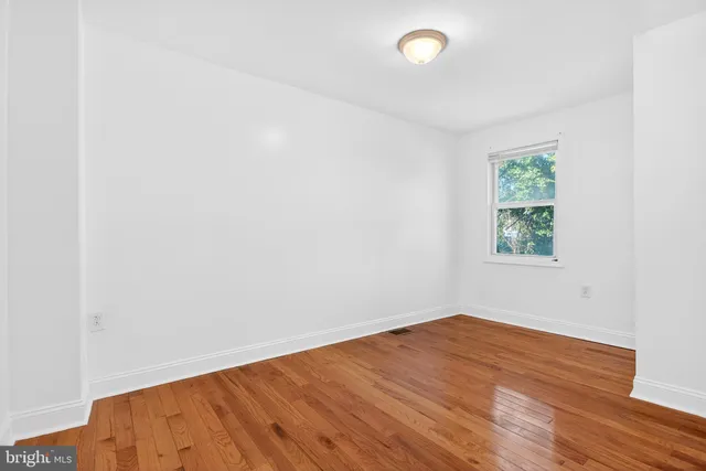 an empty room with wooden floor