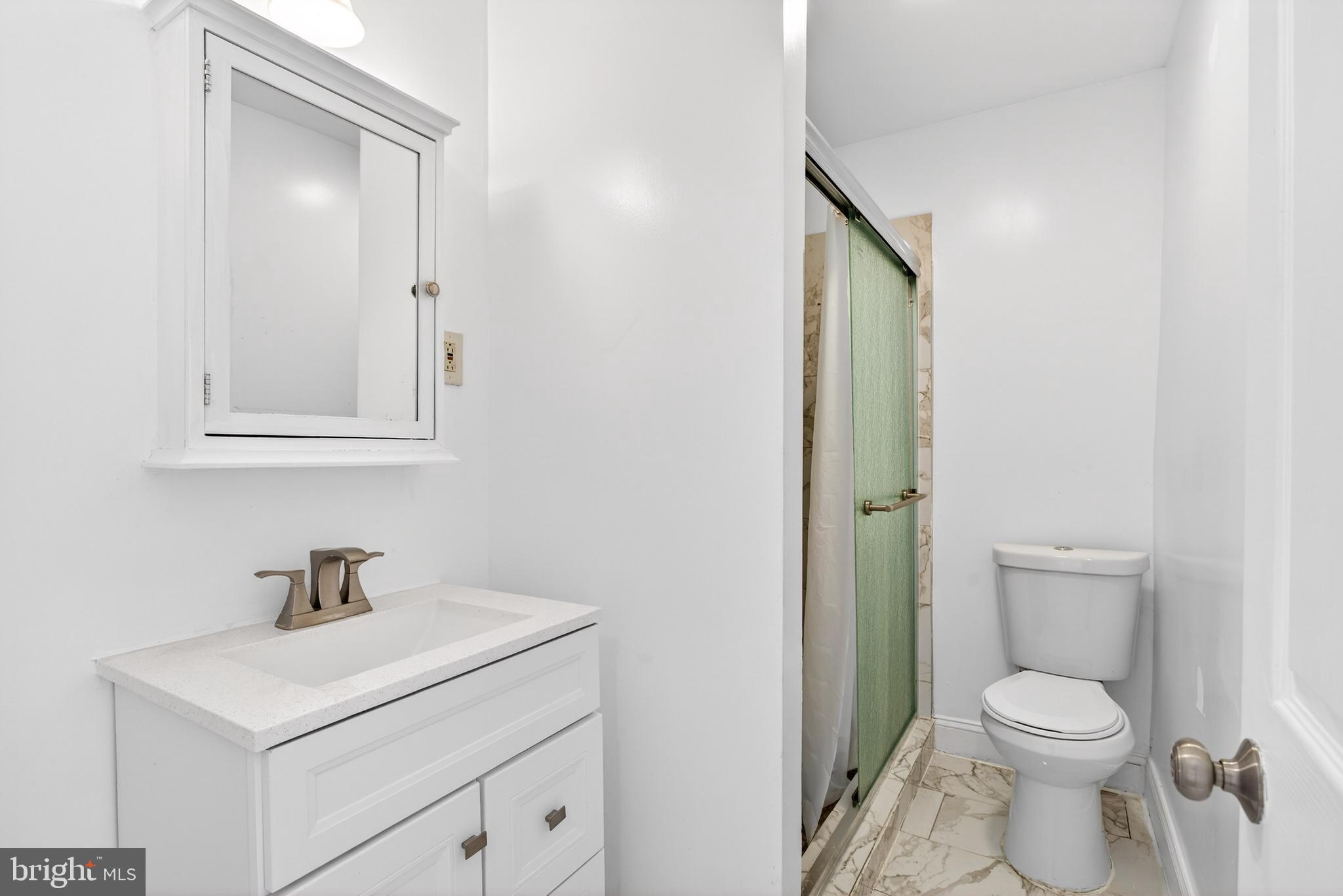 5119 Sheldon Street Philadelphia, PA 19144 - Photo 17 of 27 a bathroom with a sink a toilet and a mirror