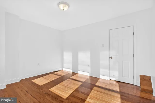 a view of a bedroom with wooden floor and bedroom