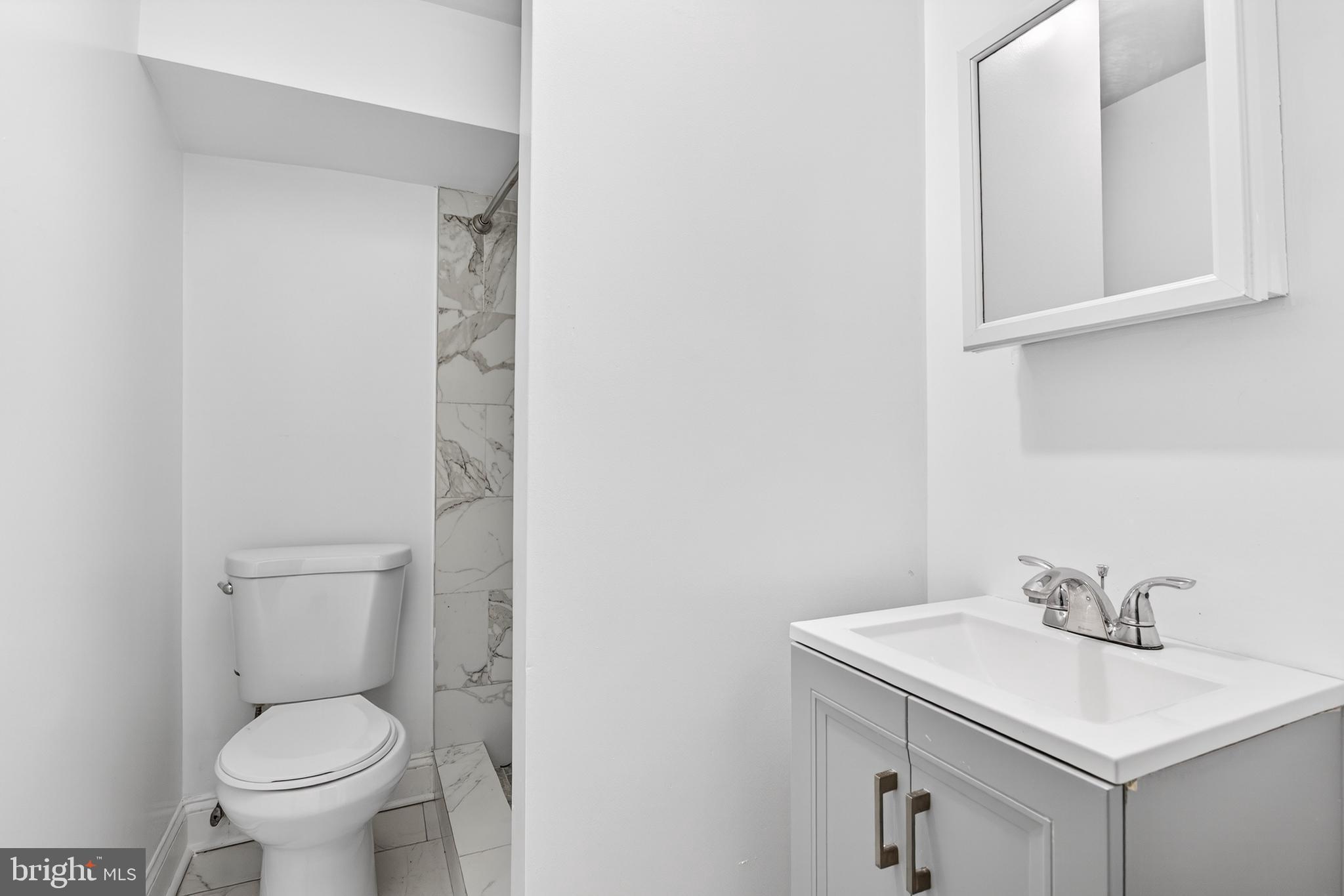 5119 Sheldon Street Philadelphia, PA 19144 - Photo 24 of 27 a white toilet sitting next to a bathroom sink