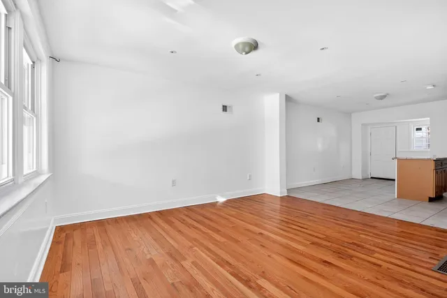 a view of kitchen and hall with wooden floor