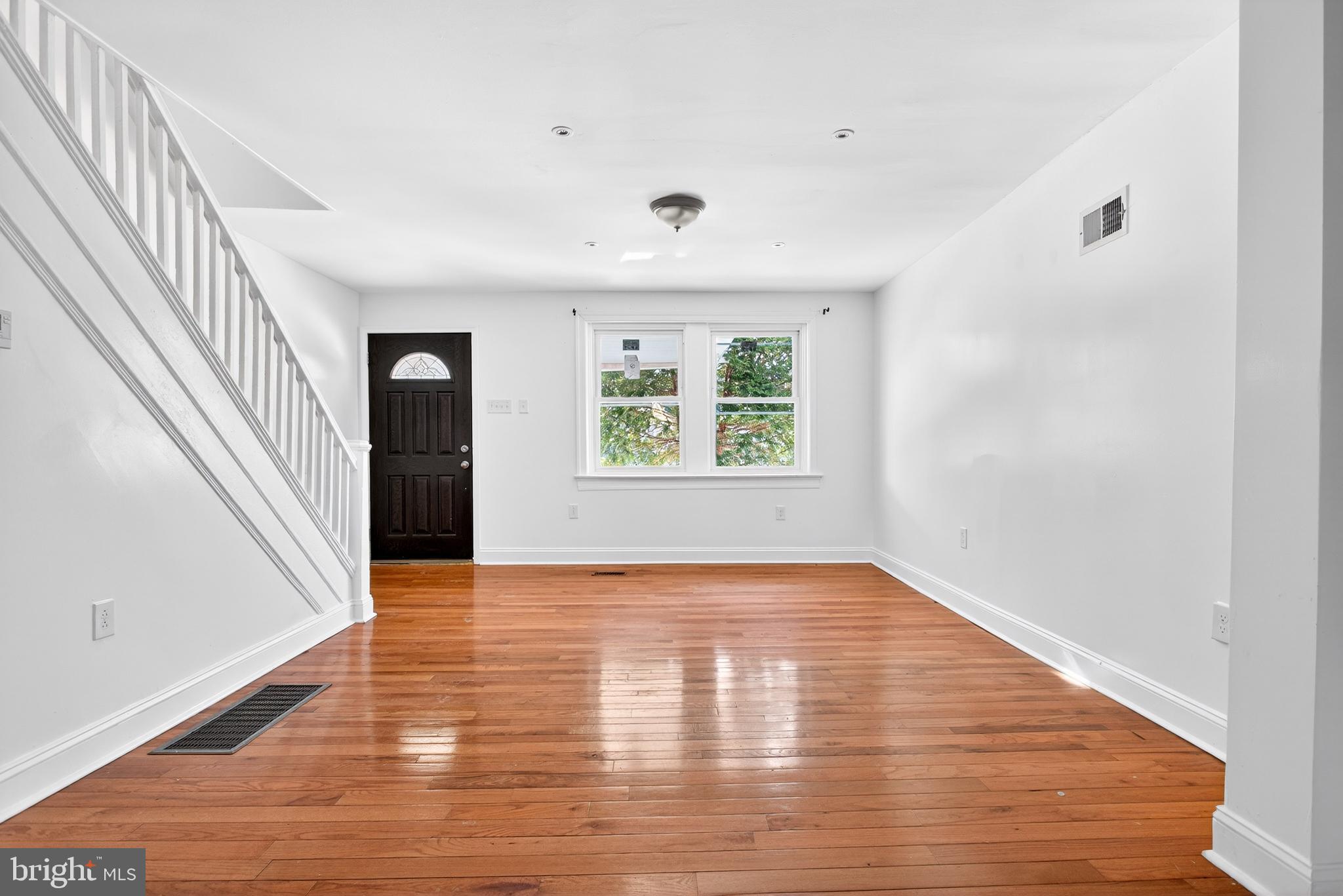 5119 Sheldon Street Philadelphia, PA 19144 - Photo 7 of 27 a view of an empty room with wooden floor and a window