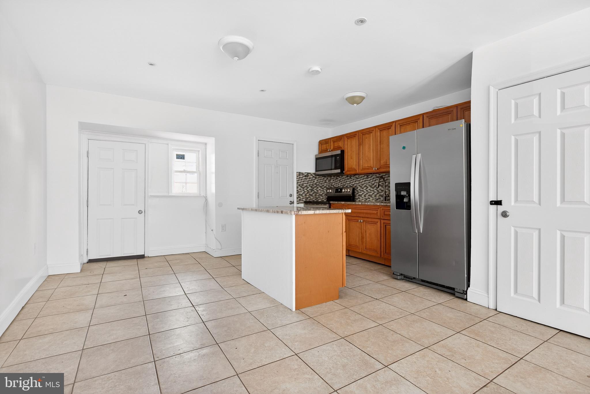 5119 Sheldon Street Philadelphia, PA 19144 - Photo 8 of 27 a kitchen with stainless steel appliances a refrigerator and a stove