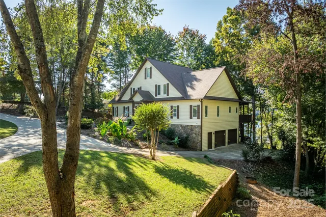 a view of house with swimming pool and garden