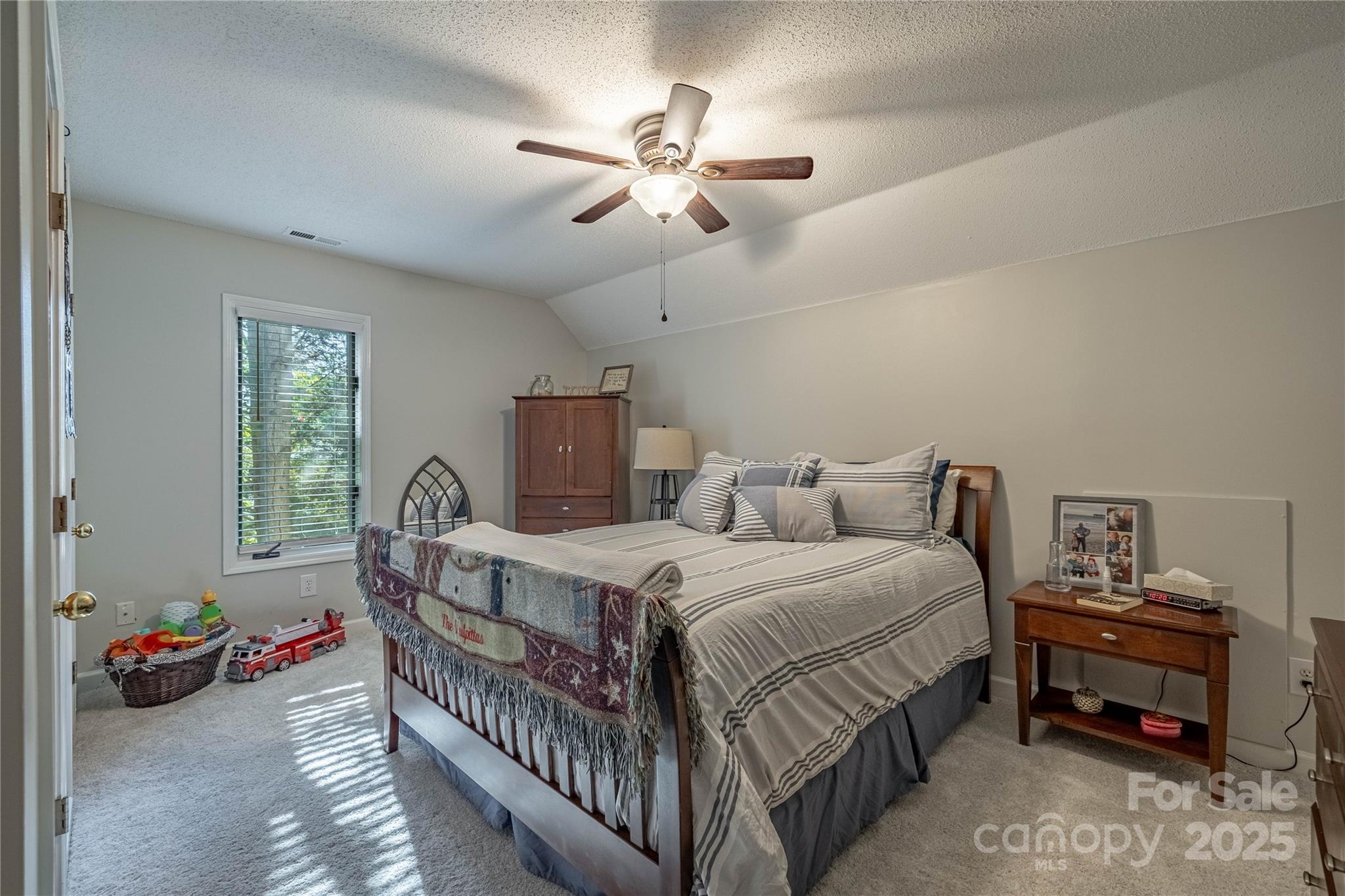316 Players Ridge Road Hickory, NC 28601 - Photo 38 of 47 a bedroom with a bed and a chandelier