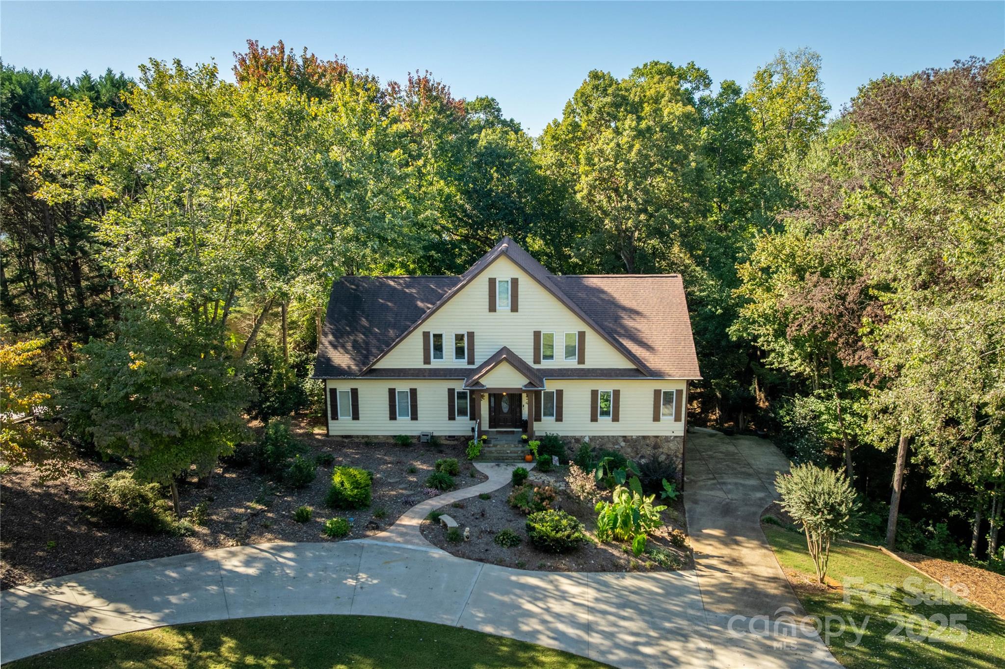 316 Players Ridge Road Hickory, NC 28601 - Photo 6 of 47 a front view of a house with a yard and a garden